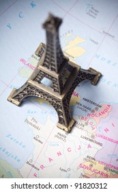 Eiffel Tower statue on a map of Paris
