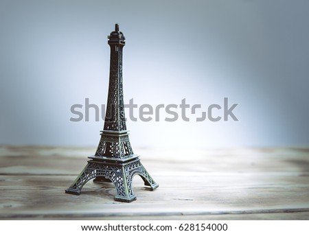 Eiffel tower statue on wooden background