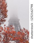 Eiffel Tower under heavy fog during an early morning in autumn
