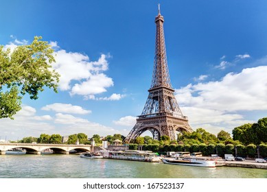 Eiffel tower view, Paris, France. Scenic panorama of Seine River and blue sky. Nice scenery of Eiffel tower and tourist boats, beautiful city landscape, Paris skyline in summer. Tourism, travel theme