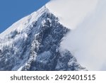 Eiger Mountain Peak: A stunning view of the iconic Eiger mountain peak in the Swiss Alps, showcasing its majestic snow-capped summit and rugged terrain.