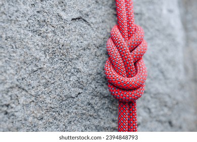 eight climbing knot with colorful rope on rocky background - Powered by Shutterstock