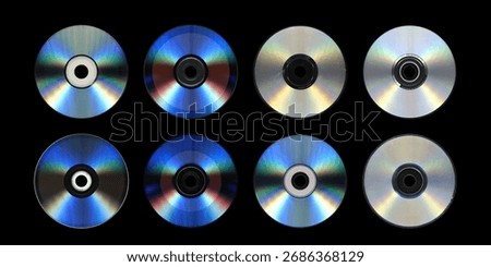 Eight Compact Discs Set on Black — Reflective Optical Media