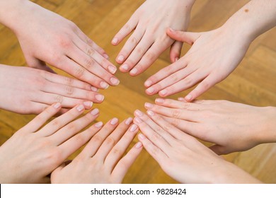 eight hands put together to form the shape of a star