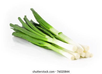 Eight ripe, beautiful spring onions on a white background.