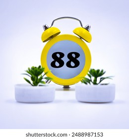 Eighty eighth number written over clock, purple background 