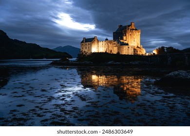 Eilean Donan castle al night. Castle near Isle of Skye. Reflection picture. Highlands of Scotland. Scotland, United Kingdom.  - Powered by Shutterstock