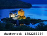 Eilean Donan Castle is one of the most important attractions in the Scottish highlands , at the point where three great sea-lochs meet in twilight with reflection,  Kyle of Lochalsh , Scotland