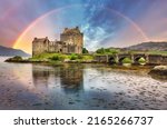 Eilean Donan Castle with rainbow and reflection in water, Scotland.