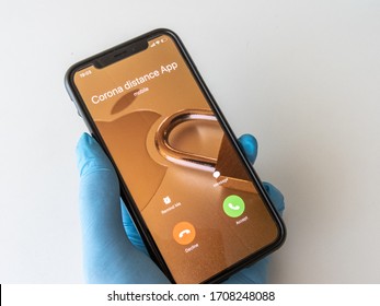 Eindhoven, The Netherlands - 19 April 2020: Close Up Smartphone IPhone From Apple Or Google With Distance Alert App. Corona Virus Or Covid-19 IOS Tracking App. Privacy And Social Distance, Bluetooth.