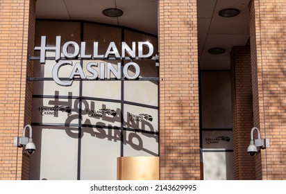 Eindhoven, The Netherlands - April 7 2022: Entrance of Dutch Holland Casino. Reflection logo or sign and letters in window. Security camera, part of a serie.