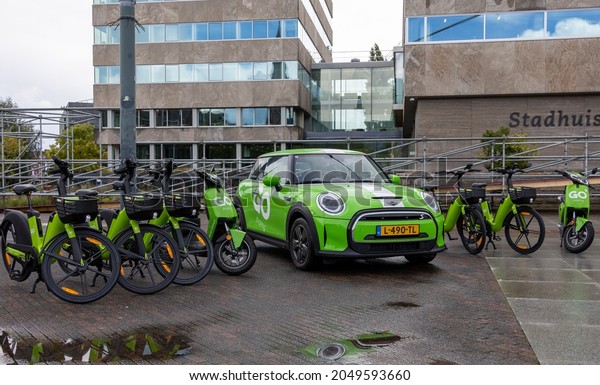 Eindhoven, The Netherlands - September 29 2021:  green\
Go Share vehicles. E-bike, e-scooter and e-car. Share bike, scooter\
or car by using Go sharing app. Sustainable vehicle , electric\
mini, serie. 