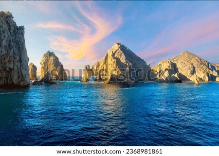 The El Arco Arch bathed in colorful light at sunset at the Land's End rock formations on the Baja Peninsula, at Cabo San Lucas, Mexico.