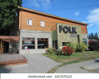 El Calafate, Argentina - 3rd January 2020: Facade of Folk Suites hotel with blue sky on the background and trees in the surroudings; an accomodation option near to Laguna Nimez.