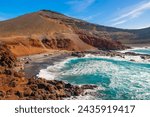 El Golfo Lanzarote Canary islands black sand beach and emerald green Olivina lagoon set against hillside of lava and beautiful blue ocean surf waves breaking and a small village