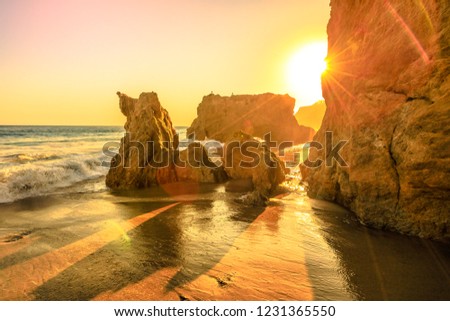 El Matador State Beach, California, United States. Sunbeams with sunset lights between pillars and rock formations of most photographed and scenic of Malibu beach, Pacific Ocean. California West Coast