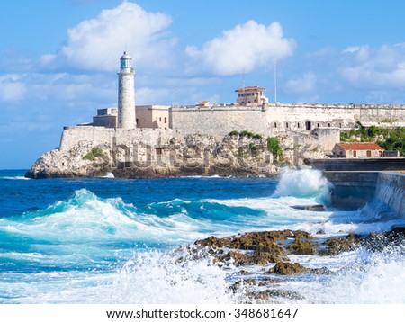 El Morro castle in Havana with sea waves crashing on the Malecon seawall