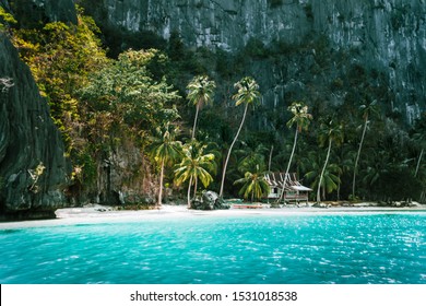 El Nido, Palawan, Philippines. Secluded tropical hut on Pinagbuyutan Island. Amazing white sand beach,turquoise blue lagoon water and palm trees - Powered by Shutterstock