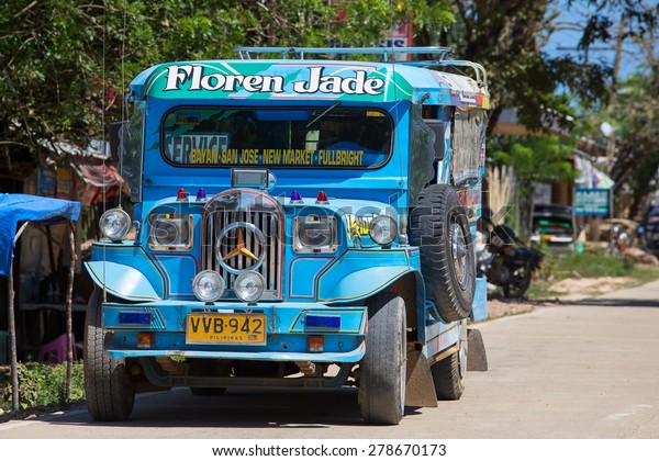 EL NIDO,\
PHILIPPINES - JANUARY 29, 2014: Jeepneys passing, Philippines\
inexpensive bus service. Jeepneys are the most popular means of\
public transportation in the\
Philippines.