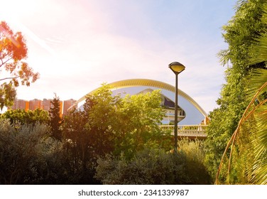 El Palau de les Arts Reina Sofía and Opera house in City Of Arts and Sciences. Futuristic complex on Park Turia river. Architectural garden of L`Umbracle gallery. Garden with palms in city park. 