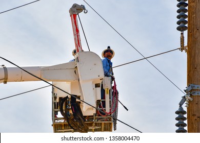 El Paso, Texas - 2 April 2019: Power company employees installing a huge, new utility pole.