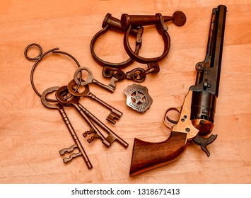 El Paso, Texas - 20 February 2019: Law West Of The Pecos. Old Time Keys And Ring, Hand Cuffs, Marshall Bade And Six Shooter.