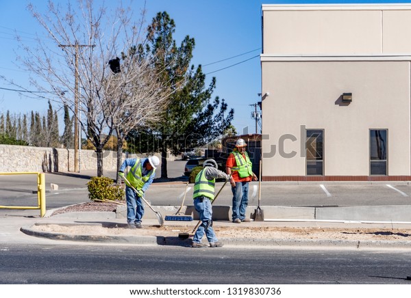 El Paso,\
Texas - 21 February 2019: Road working crew hard at work repairing\
one of El Paso\'s busiest\
streets.