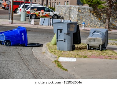 El Paso, Texas - 22 February 2019: Trash Collection Day And Strong, Dusty Winds  Make For A Mess.
Trash Barrels Pose A Navigation Hazard For Drivers.