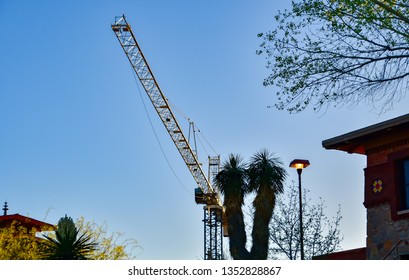 El Paso, Texas - 28 March 2019: 
Construction Crane At Sunset On The UTEP (University Of Texas At El Paso) Campus.