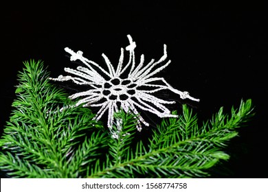 El Paso, Texas / USA: Circa November 2019
Cute Handmade Christmas Ornament On A Black Background With Pine Branches.