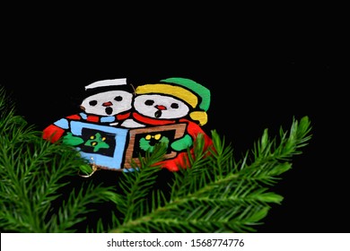 El Paso, Texas / USA: Circa November 2019
Cute Handmade Christmas Ornament On A Black Background With Pine Branches.