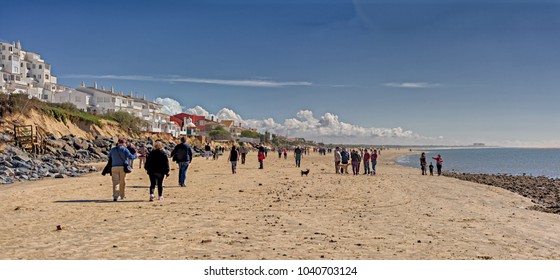 El Portil, Spain. Circa March 2018. People On The Beach Watch Ocean Front Homes Damaged By Winter Storm In El Portil, Huelva; Panoramic View.