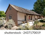 El Rancho de Las Golondrinas (The Ranch of the Swallows), historic rancho, now a living history museum near Santa Fe, New Mexico. Casa de Mora (Mora House) with large adobe home with a covered porch.