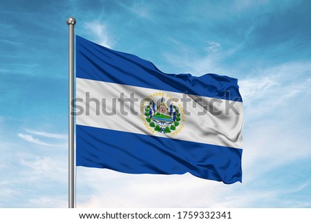 El Salvador national flag cloth fabric waving on beautiful sky.