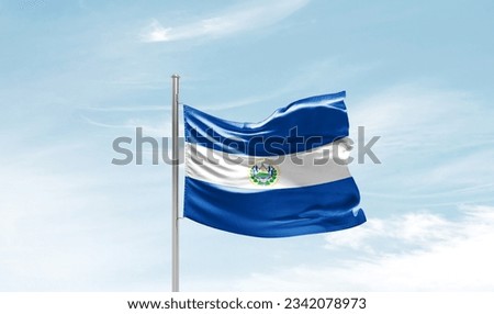 El Salvador national flag waving in beautiful sky.