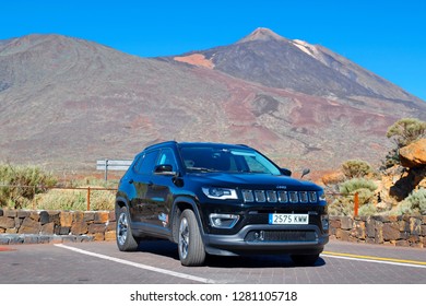 El Teide National Park, Tenerife / Spain - December 22, 2018 :Traveler parked Jeep Compass SUV at the foot of volcano Teide.The picture shows the possibility of traveling by car on theTenerife island.