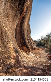 Elachbutting Rock in the eastern Wheatbelt region of Western Australia is a spectacular natural granite rock formation. An outback monolith with caves and a wave shaped wall.