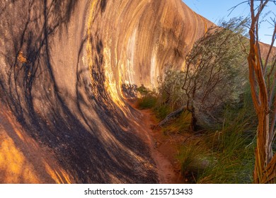 Elachbutting Rock in the eastern Wheatbelt region of Western Australia is a spectacular natural granite rock formation. An outback monolith with caves and a wave shaped wall.