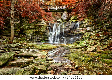 Elakala waterfall in Blackwater Falls State Park in West Virginia during autumn with red leaves foliage