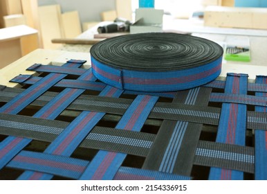 Elastic band for furniture production industry on a sofa. Furniture is ready for upholstery. Furniture manufacture. 