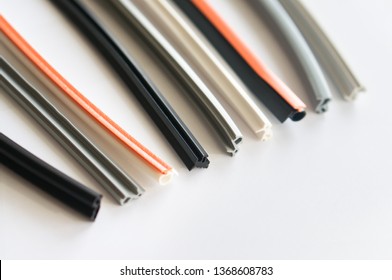 Elastic Colored Seals For Plastic Windows And Profiles On A White Background. Suitable For Advertising Gaskets And Strips For The Production Of Plastic Windows Or Window Repair Services.
