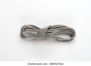 Elastic Grey Shoe Laces In A Skein On A White Background. Close-up.