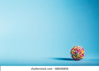 Elastic Rubber Band Ball On A Blue Background