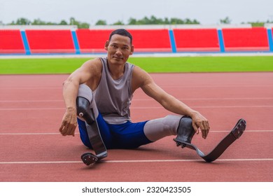 Elated Asian speed runner, donned in two prosthetic running blades, sits on the stadium track, taking a breather after a fulfilling speed running practice session - Powered by Shutterstock