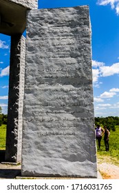 Elberton, GA/USA - April 26 2020:
Full view of granite slab at the Georgia guidestones with the tenets of the monument engraved in Arabic