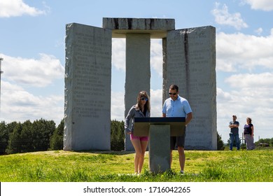 Elberton, GA/USA - April 26 2020:
View from the east of a couple reading the information plaque about the Georgia Guidestones