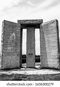 Elberton, Georgia / USA - August 23 2012: Black and white photo of the mysterious Georgia Guidestones, huge slabs of granite inscribed with instructions in many languages, in a remote field.