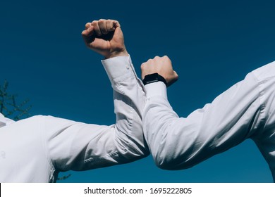 Elbow bump. New novel greeting to avoid the spread of coronavirus or covid-19 ncov. Two business man meet in a street with bare hands. Instead of greeting with a hug or handshake. - Powered by Shutterstock