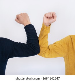 Elbow bump - a new and safe way of greeting to avoid the spread of coronavirus (COVID-19), an alternative to handshake and hugging 
