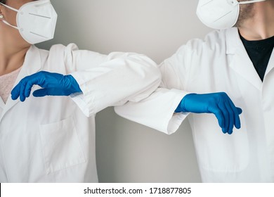 Elbow Bumping. A New Way Of Greeting To Prevent The Spread Of The Coronavirus (COVID-19). Two Doctors Bump Elbows Instead Of Greeting With A Hug Or A Handshake In The Hospital.